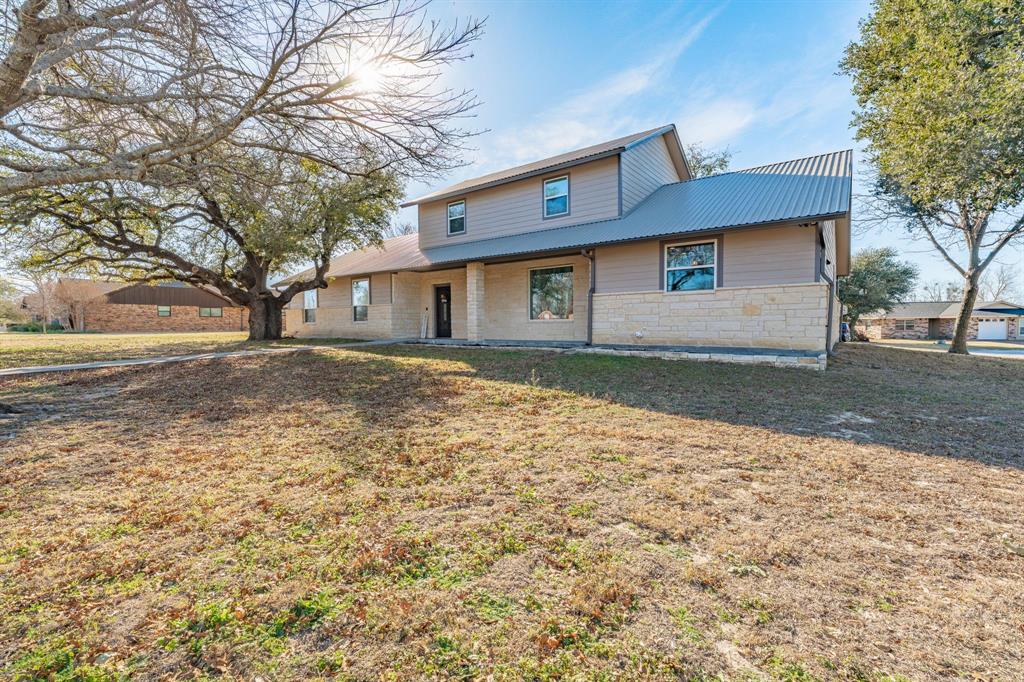 Beautiful like new home!! Check this one out! This home was completed in 2022 and is absolutely beautiful! It is a large home and features 4 bedrooms, 3 full baths and one half bath! There are two living areas that are extremely spacious! The main living area is located right next to the kitchen and dining areas! All combined that make a very large area for your family to live! The second living room is upstairs and would make a fantastic movie room, game room or a kids play area! There is also a detached three car garage that has an apartment! The apartment has a kitchenette, as well as a full bathroom! This living space and rooms are not factored into the square footage and number of rooms on the listing! There is also water well that is connected to the apartment and can be used for irrigation! This home is basically like new, and is move in ready! This one is one of the nicest homes in Erath county! If you are looking for a large, move in ready home, this is the one! So come take a look and make it your very own!