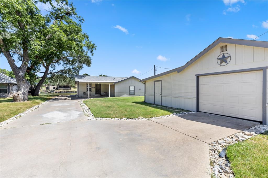 Just in time for summer fun, year round living on the lake, vacation spot or VRBO. Nice 2 bedroom 2 bath home with a 272 sq ft screened in porch plus an additional 360 sq ft covered porch to view and enjoy the lake. Attached carport and garage PLUS an additional garage and workshop. There is a permitted open dock and you very own private boat ramp all on Lake Granbury Nassau Bay. Enjoy boating, swimming, fishing, fine dining, boutique shops and all the amenties that make Granbury a great place to live. Home sells furnished. Also offered is the home and shop at 3806 and 3808 Sandy Beach Dr. MLS # 21287585