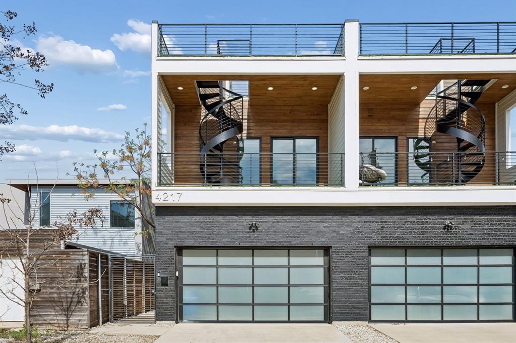 4217 Roseland Ave in East Village

New construction duplex by Osman Custom Homes, completed 2022. Bold contemporary design in one of Dallas's most walkable neighborhoods — 75 Walk Score.

Main level features soaring ceilings, white oak stained engineered hardwood floors, and an open layout built around a show-stopping 12-foot quartz waterfall island. Gas range, stainless appliances, white shaker cabinets, and matte black hardware. Sliding doors open to a private turfed yard with a gas fireplace.

All bedrooms live upstairs. The primary suite includes a balcony, dual-vanity bath with LED mirrors, freestanding soaking tub, and rain shower wrapped in floor-to-ceiling stone. Four full bathrooms total, each with designer tile and quartz finishes.

A gorgeous spiral staircase lead from the front patio to a private rooftop deck — perfect for entertaining with skyline views.

Three turfed patios. Turfed yard. Zero maintenance, always green. Frosted glass garage doors. Modern fixtures and finishes throughout.

East Village living at its finest.