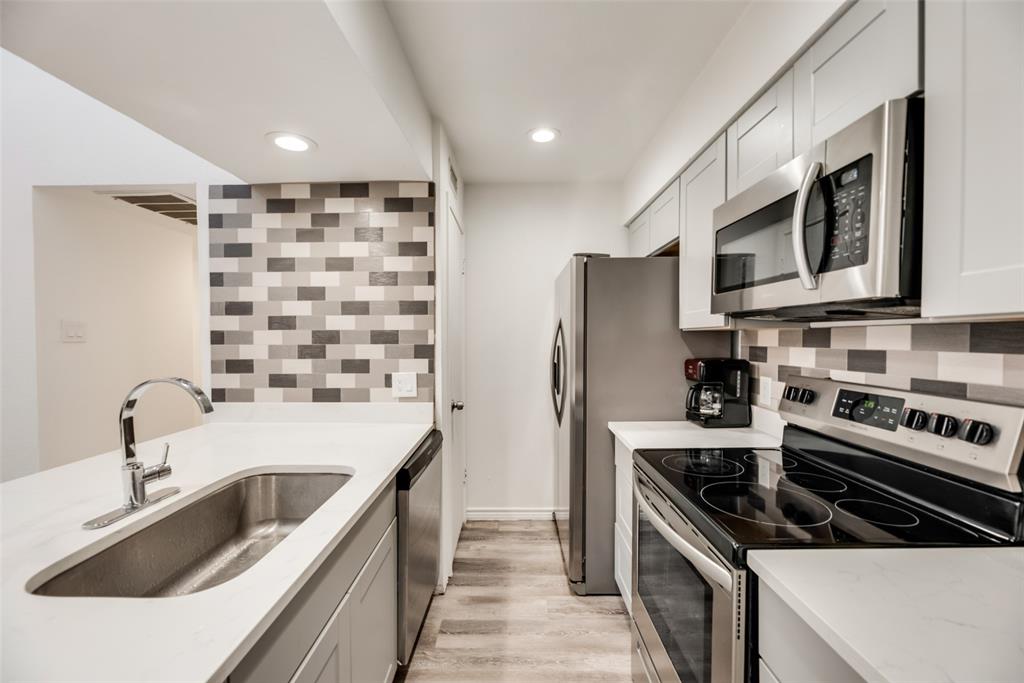 Welcome to this nicely remodeled condo offering comfortable and convenient living with a functional layout and thoughtful updates throughout. The open living, dining, and kitchen areas flow seamlessly together, creating a bright and inviting space enhanced by vaulted ceilings and abundant natural light. The kitchen features stainless steel appliances, ample cabinet storage, and a breakfast bar that is ideal for everyday living and casual entertaining. Updated finishes throughout provide a clean, modern feel while maintaining a warm and comfortable atmosphere. The spacious bedrooms offer flexibility for a variety of needs, while the bathrooms have been updated with both style and practicality in mind. A private balcony provides a quiet place to enjoy morning coffee or relax at the end of the day. Residents can enjoy community amenities including a pool and walking trails, and two dedicated covered parking spaces are included for added convenience. With easy access to major highways, commuting around Dallas is simple. The property is located near everyday shopping, grocery stores, restaurants, and entertainment options, including NorthPark Center, The Shops at Park Lane, White Rock Lake, and a variety of local dining destinations. Whether you're looking for a primary residence or an investment opportunity, this move-in-ready condo offers a low-maintenance lifestyle with modern updates and convenient access to many of Dallas' popular destinations.