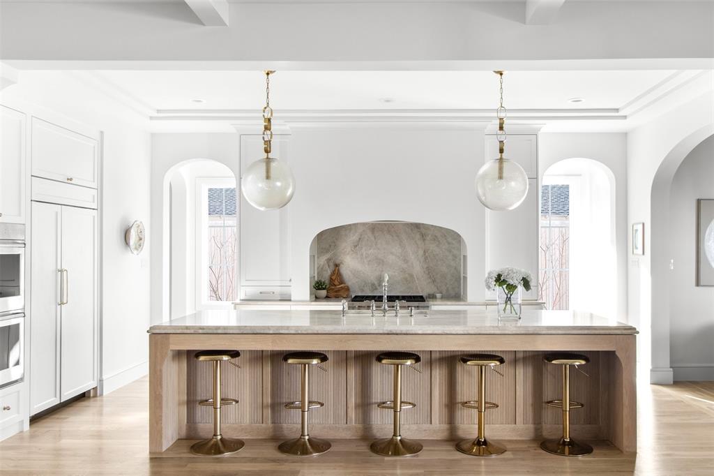 Designed and built by Jessica Koltun Home, this striking Midway Hollow residence is a sophisticated transitional home offering 5 bedrooms and 5 bathrooms, thoughtfully composed to balance modern elegance with everyday functionality. Bright, open interiors are anchored by clean architectural lines, generous ceiling heights, and carefully curated finishes—including designer light fixtures and plumbing—that create a cohesive, warm aesthetic throughout.

Expansive living areas flow effortlessly into a chef’s kitchen defined by premium materials, custom cabinetry, and an oversized island ideal for entertaining and daily life. A guest bedroom is conveniently located downstairs, while private bedroom suites throughout the home provide comfort and privacy, including a serene primary retreat designed for rest and relaxation.

Upstairs, a spacious game room and an additional flex room offer versatility for work, fitness, or media. The large backyard is thoughtfully designed with turf and concrete pavers, creating a low-maintenance outdoor space with an additional seating area perfect for gathering and entertaining.

Architectural detail, elevated craftsmanship, and high-end fixtures and finishes are evident at every turn, while the seamless indoor-outdoor connection enhances everyday livability. Ideally located in one of Dallas’s most desirable neighborhoods, this residence reflects timeless design, quality construction, and a true sense of luxury.