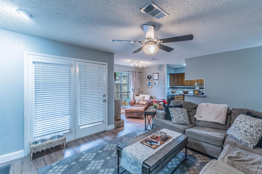 20K IN UPDATES in this FIRST FLOOR condo in the GATED community of the Cloisters. Spacious living area with a beautiful tile fireplace and a sitting area or breakfast nook overlooking the private patio. Kitchen is open to the living area and features a breakfast bar, double sinks, tile backsplash and beautiful granite countertops. Completely updated bath with a large walk-in shower and double sinks adjacent to the primary bedroom. Luxury vinyl plank floors and neutral colors throughout. Floors are also waterproof. Location and Luxury in this 2 bedroom one bath Gem.  Minutes from Globe Life Field, AT&T Stadium, Texas Live and Arlington's new entertainment District.  Situated between Dallas and Fort Worth off of I30 and 360 and less than 10 minutes from DFW Airport.  Two reserved parking spaces directly in front of the unit. Amenities include a beautiful pool, tennis courts, racquetball, a clubhouse and much more. Show and sell this condo today.