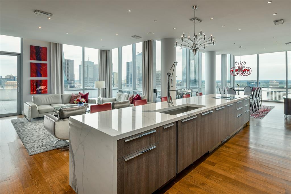 Breathtaking views await from this sensational sub-penthouse condo at The House, an incredible 28-story building designed by Phillipe Starck overlooking 180-degree panoramic views of Downtown, Margaret Hunt Hill Bridge & Trinity River Corridor. Completely remodeled & perfect for an art collector, the ultra-sleek contemporary interiors reveal a showstopping open floor plan with chic living & dining spaces & floor-to-ceiling windows with views from almost every room. The 1255 SF terrace is one of the largest balconies in the building & perfect for hosting large gatherings. From the stunning custom Porcelanosa kitchen boasting Miele appliances & a waterfall island with illuminated onyx backsplash & bar seating for 5 to the luxurious private spaces with spa-like limestone baths, this is high rise living at its finest. 24hr security, concierge, valet, pool terrace with 130-foot saltwater infinity pool, spa, cabanas, owner's lounge, guest suite, gym, conf. center, storage & 2 parking spaces.