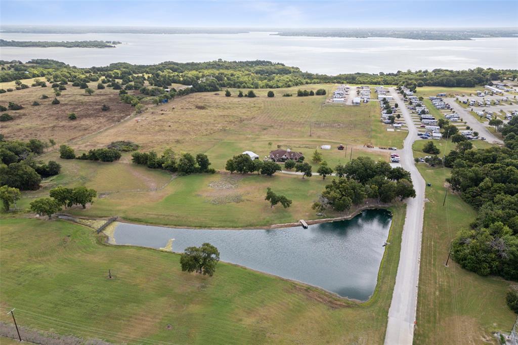 This is a unique opportunity to own 38.397 acres backing to Lake Lavon & Corps of Engineers land situated in Princeton, a gem for developers or someone looking for a turnkey RV park buisness plus land. Own a fully operational and leased, meticulously maintained RV park & storage business, plus an additional 30+- acres ready for commercial or residential development with stunning lake views. You'll find tranquil lakeside living that backs to Lake Lavon and Army Corps of Engineer land. Located in County, NOT within the city or ETJ - no city taxes. Outside of the city limits, commercial zoning, & pasture land. Per the seller, Property is ready with aerobic septic systems, power & a new 8' water line was just added at the street near the property. Approx 1133 feet of LAKE Lavon frontage to the Corps of Engineers land along the lake which should remain undeveloped & which includes walking access to the waters & shoreline of Lake Lavon. Many new homes are being built in the immediate area. Property is ideal for commercial business, residential, or combo development with lake access. It might be possible to tie into the the nearby sewer development for a fee as other developments are doing. This could allow for high density and multi-story development overlooking the lake. This area is located in the county not city or ETJ. Approx 479 feet of road frontage on Hawthore Drive with pipe fencing and  nice entry drive.  Additional 1 acre may be available for purchase. Princeton TX was just named the 3rd fastest growing city in America by the US Census Bureau. New construction is booming all around this prime real estate opportunity. Lake Lavon offers fishing & boating, swimming & picnicking along its shores. Many new homes are being built in the immediate area.