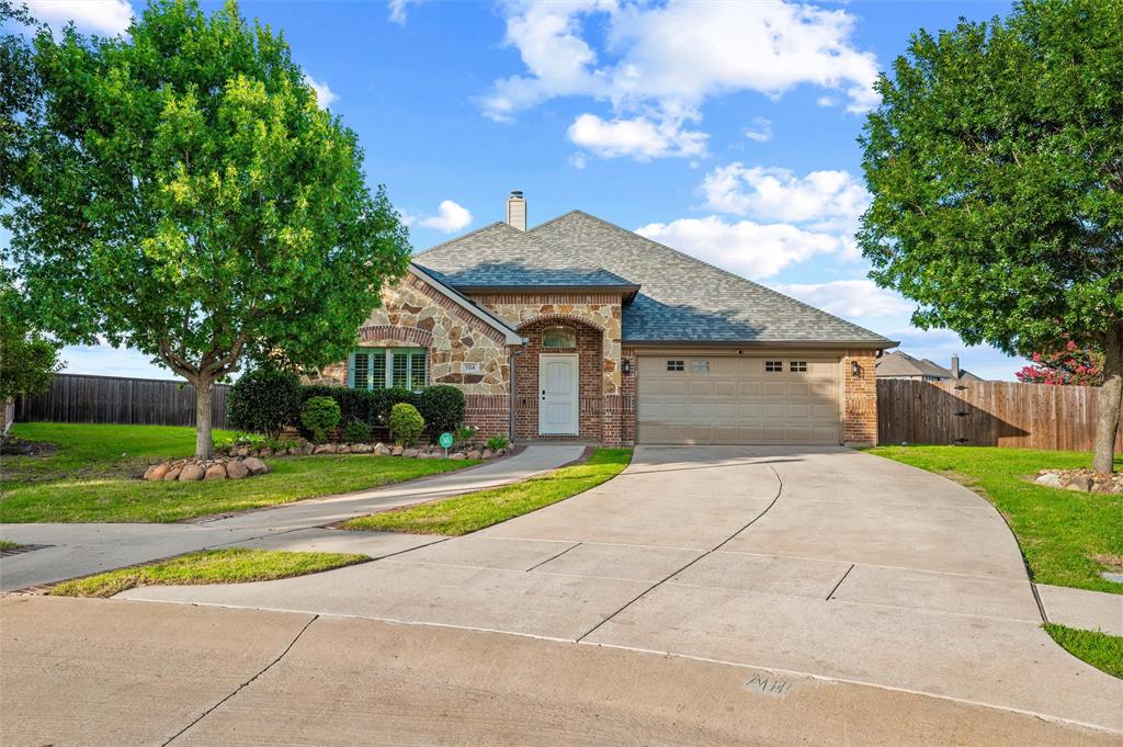 Welcome to 164 Horseshoe Bend, a home that immediately stands out for its classic curb appeal, beautifully maintained finishes, and resort-style backyard. The brick and stone exterior, mature landscaping, covered front entry, and inviting roofline create a polished first impression before you ever step inside. Once inside, warm wood flooring, neutral paint, crown molding, plantation shutters, and abundant natural light give the home a clean, timeless feel. The main living area is anchored by a striking white stone fireplace and offers an easy connection to the kitchen and dining spaces, giving the layout a comfortable flow for everyday living and entertaining. The kitchen features crisp white cabinetry, granite countertops, a tumbled stone backsplash, glass-front cabinet accents, stainless appliances, a built-in oven and microwave, under-cabinet lighting, and generous storage. The dining area overlooks the backyard and brings in beautiful natural light, creating a bright place for meals, conversation, and relaxed mornings at home. The floor plan offers great flexibility with multiple living and dining options, well-sized rooms, and thoughtful flow throughout. The backyard is where this home truly shines. A covered patio opens to a sparkling in-ground pool with stone coping, generous decking, mature trees, and plenty of room to relax, host, swim, or enjoy quiet evenings outside. The outdoor space feels private, inviting, and ready for both weekend gatherings and slow nights at home. With a fenced yard, 2-car garage, warm interior finishes, and a backyard that feels like an extension of the home, this property delivers the comfort, charm, and lifestyle buyers are searching for.