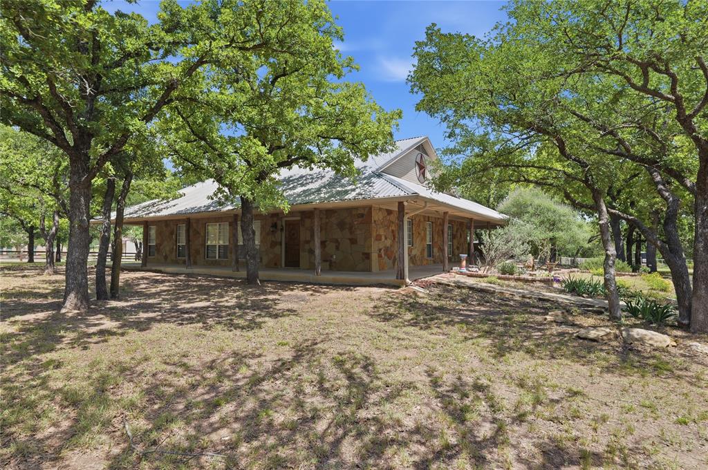 Oaks, Oaks and More Oak Trees on this 2.35 acre lot with NO HOA! Situated between small hobby farms and other quality subdivisions is a home with a ranch house rustic look nestled within hundreds of oak trees.  Located minutes from I-20, the BROCK ISD campuses, and sugar tree golf course, this property allows you navigate to any destination with ease.  Feel free to bring the horses, livestock or construct the other improvements you desire on a scale that you want.  The home embodies an open, split-level layout, big porches, and other quality custom features.  Appliances and water heaters all 4 years old and newer. Homes on lots like this in Brock are hard to find, with the added bonus and freedom of no restrictions and HOA!