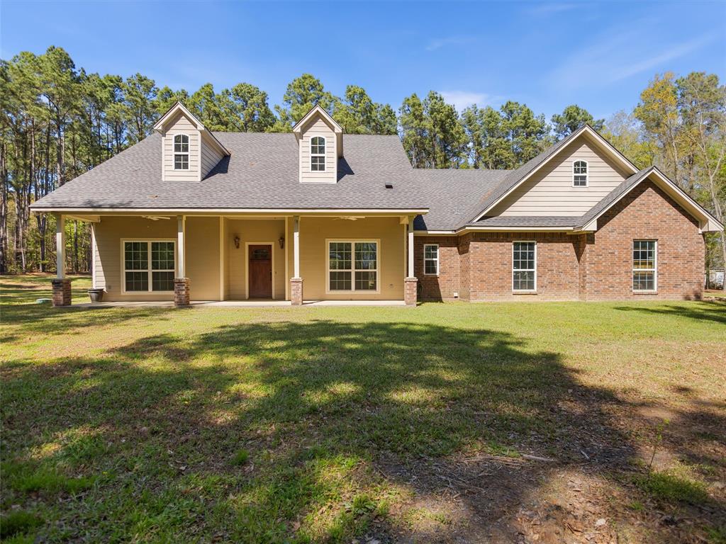 Here is the picture perfect home you’ve been looking for! Located on 5 acres of pristine land surrounded by mature trees that offer the most privacy. This home is located in Harmony ISD and is only 13 minutes from the heart of Gilmer. As you enter you are greeted with high ceilings, lots of natural light and an open concept living space that has just the right set up. On one end of the home you’ll find the two guest rooms, one has an oversized closet. The two rooms are connected by a Jack and Jill bathroom with one half that acts as a powder bath for guests. As you flow back across the living space you’ll find the laundry room, the oversized garage that can fit most trucks and a hallway that leads to the primary suite. There you will find a spacious bedroom with a door that leads to the patio. The en-suite bath is also sizeable and offers a tiled walk in shower, a soaking tub, separate vanities and a spacious walk in closet. From there you can head out back to find a vast amount of covered patio space which is ideal for relaxing or entertaining. There is also a fire pit area right off the patio. This home checks all the boxes and just might be exactly what you’ve been looking for. Come take a look and see