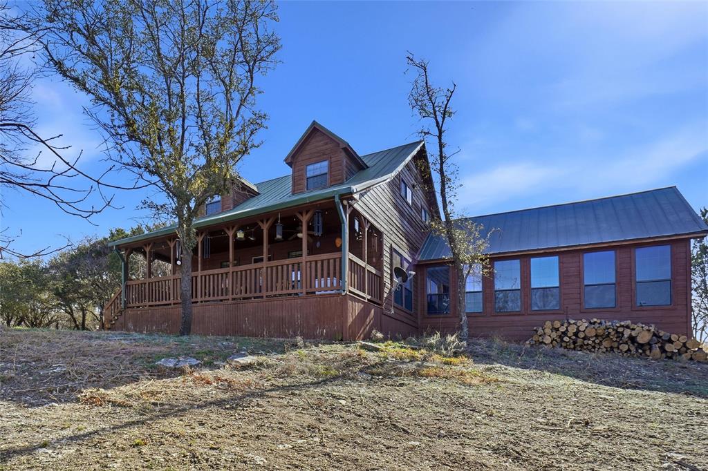 Are you looking for a community in the country? A community filled with scenic views, lakes, and wildlife? Then look no more and welcome to your new home! Down to earth luxury, peacefully situated.  A perfect home for those who want acreage, amenities and all that Mountain Lakes Ranch has to offer. 5-acre property comes with a gazebo, storage shed, wildlife observatory and large covered deck with ceiling fans, perfect for enjoying nature. The heart of the home is spacious, bright, ideal for gatherings. Hardwood laminate flooring welcomes you throughout the open floor plan. Cedar accents throughout the home give it a real lodge or western feel. Classic white shaker cabinets, stainless steel appliances, a big kitchen island add a modern update to the rustic feel. Vaulted ceilings and built in shelving give the primary bedroom an extra touch of elegance, the rolling library ladder adds a touch of old world craftmanship. The 4 windows in the primary bedroom provide a scenic overlook of the property and a peaceful escape from city life. The back porch makes a wonderful retreat to relax and reflect. Property includes 2 large outbuildings that can be used for multi-purpose. The Gazebo is nestled under the trees and provides a great place to gather. Stay warm and dry in the wildfire observatory- deer blind while observing the wildlife. The utility room off the kitchen has a built in doggie door to the fenced front yard, providing a safe and effective way to care for your pets. All Measurements and dimensions are approximate and deemed to be reliable, but are not guaranteed, and should be verified by the buyer. (Property Includes gazebo, picnic table, browning smoker, wildlife observatory- deer blind). American Home Shield warranty is  transferrable. Additionally there is a transferrable Aerobic Septic Service Contract valid through Jan 2027.  Update, Jimmy Houston Way has been newly paved. Seller could also consider a points buy down in lieu of a price reduction.