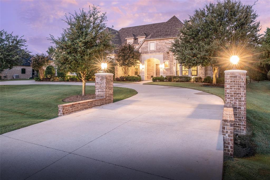 Welcome to this exquisite custom estate in coveted Lovejoy ISD! This breathtaking single-story custom home was built by renowned builder Cleve Adamson. Set on a 1-acre lot with unmatched craftsmanship and design. The beautiful curb appeal with circular drive and stately façade set the tone for this luxurious retreat. Step inside to soaring 12-foot ceilings with wood beams, open-concept living, and elegant designer finishes throughout.The chef’s kitchen is a true showpiece featuring a massive single-slab quartzite island, double electric ovens, pot filler, double-door built-in refrigerator, and a seamless flow into the dining, breakfast, and living spaces—all overlooking the backyard oasis. Relax and entertain outdoors with a gorgeous outdoor kitchen and the recently updated pool, expansive covered patio, gas-log fireplace, and motorized screens for year-round comfort. Work from home in the stunning office, complete with oversized glass French doors, ceiling speakers, and a private courtyard surrounded by brick and wrought iron. Guest quarters is split from secondary bedrooms closet is equipped as a safe room! Remaining 3 bedrooms are on the opposite end of the home. All rooms are have ensuite bathrooms. One bedroom is currently decked out as a gym. Car enthusiasts will fall in love with the 5-car garage complex, including a 1,500 sq ft heated and cooled garage designed with every detail in mind some details are: 12’ ceilings to accommodate lifts, copper piping for air distribution with 5 outlets and 2 hose reels, 2 industrial 240V outlets, commercial divider curtain, 2000-lb crane access to the “Texas Basement”, Epoxy-coated floors, electrical reels, ceiling speakers, and abundant storage. Additional highlights include whole-home spray foam insulation and a generator. This is more than a home — it’s a masterpiece of design, functionality, and luxury living in one of Fairview’s most desirable neighborhoods. 
Additional features list available on MLS and upon request