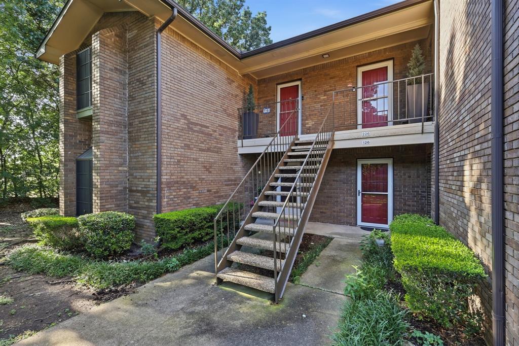 Looking for a peaceful, treed setting while still being minutes from downtown Dallas & Bishop Arts District?  Look no further- this 2nd floor updated 1 bedroom, 1 bath condo is set within a canopy of mature trees and is right beside Stevens Golf Course!  The open floor plan draws you in and offers plenty of space to live and entertain.  Upgraded woodlike floors, neutral paint & crisp white trim & molding throughout elevate the interior.  Updated kitchen includes stainless steel appliances, white quartz countertops and fridge, all opening to the spacious living room with wood-burning fireplace & gorgeous views of the treed open yard from French doors & wall of windows.  Sizeable bedroom offers a private closet & picturesque box window seat.  Other amenities in the unit include a washer & dryer, upgraded vanity & countertop in bathroom & less than one year old breaker box.   Prepare to spend hours on the oversized balcony with views of serene trees, creek & vast shared yard.  A gate takes you out into Stevens Golf Course and nearby Coombs Creek Trail and Kessler Park.  The side yard will be landscaped by the HOA sometime this year.  HOA includes 2 sparkling pools to enjoy, water, trash, sewer, and exterior maintenance.  Condo roof was replaced in 2026.  Come see in person to experience the gorgeous views and perfect setting!