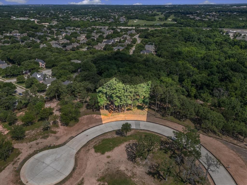 Welcome to The Bluffs, an exclusive gated luxury community of only 9 estate home sites nestled atop the rolling, wooded hills of Colleyville. Lot 5 presents a rare opportunity to build your custom dream estate on a generous 1+ Acre corner home site, surrounded by mature trees and bordering a natural creek.

The Bluffs is more than a community—it is a lifestyle. With only 9 home sites in this private enclave, residents enjoy breathtaking elevated views, unmatched privacy, and a tranquil atmosphere defined by the natural beauty of the surrounding woodland and creek. Just across the street, Parr Park provides immediate access to trails, open green space, and outdoor recreation for the entire family.

Residents are served by Grapevine-Colleyville ISD, including Glenhope Elementary, Cross Timbers Middle School, and Grapevine High School—consistently recognized among the top-performing districts in North Texas. World-class shopping and dining at Southlake Town Square and Colleyville Town Square are just minutes away. DFW International Airport is approximately 10 minutes from your door, with Downtown Fort Worth roughly 20 minutes and Downtown Dallas approximately 25 minutes away—placing the best of the Metroplex always within reach. Your legacy estate in The Bluffs begins here.