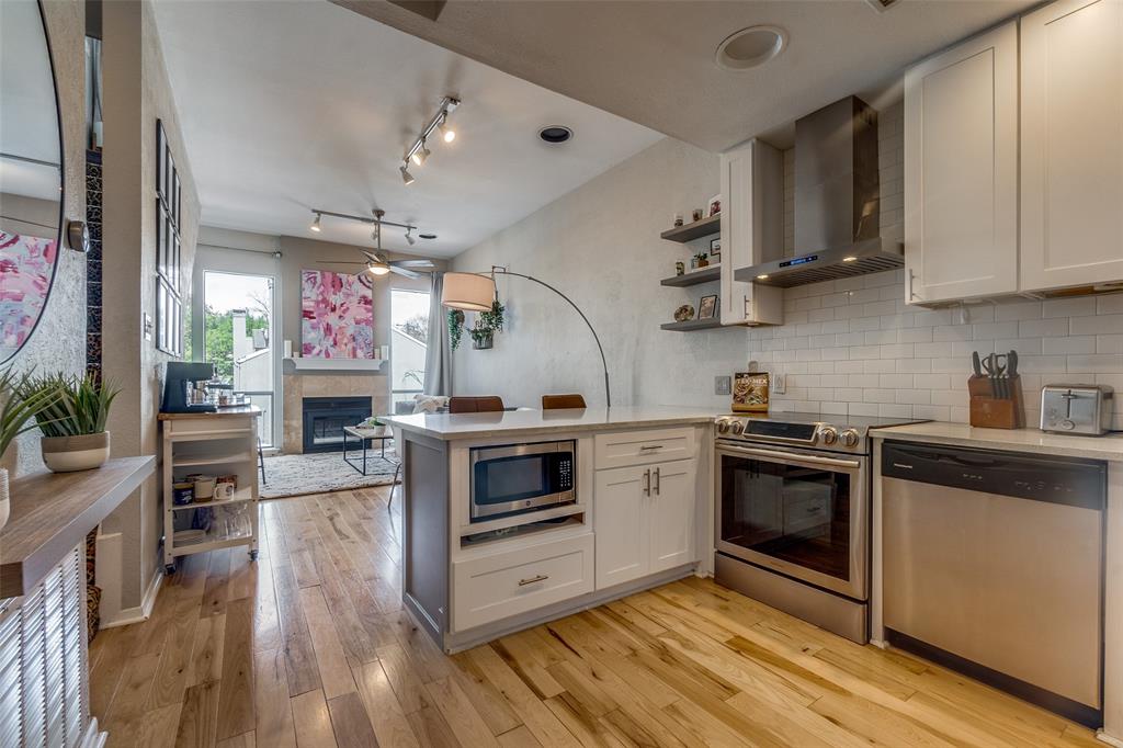 Nestled in the vibrant heart of Oak Lawn, this sophisticated two-story condo offers a premier urban lifestyle just moments from Dallas’ most celebrated high-end dining and retail. Step inside to find a light-filled, open-concept sanctuary where modern elegance meets everyday functionality. The main level boasts rich hardwood floors and a seamless flow from the inviting living area, anchored by a sleek electric fireplace, into a chef-inspired kitchen. Featuring crisp white shaker cabinetry, premium quartz countertops, a kitchen bar, and stainless-steel appliances, this space is as perfect for hosting soirées as it is for quiet morning coffees. Ascend to the second level to discover the expansive primary suite, a versatile haven with ample room for a dedicated home office or a private sitting area. Organization is effortless thanks to two generous custom closets, while stylish laminate flooring adds a contemporary touch. Smart home features, including a Ring doorbell and Nest thermostats, ensure comfort and security are always at your fingertips. Beyond your front door, the community amenities cater to both relaxation and convenience. Spend sunny afternoons lounging by the sparkling pool or enjoy quality time with your four-legged friend at the private dog run. The property also includes a shared, assigned one-car detached garage with extra storage and dedicated hookups for a stackable washer and dryer. Combining stylish finishes with an unbeatable location, this isn't just a home - it’s your gateway to the very best of Dallas living. Experience the energy of the city while enjoying the refined comfort of your own urban retreat.