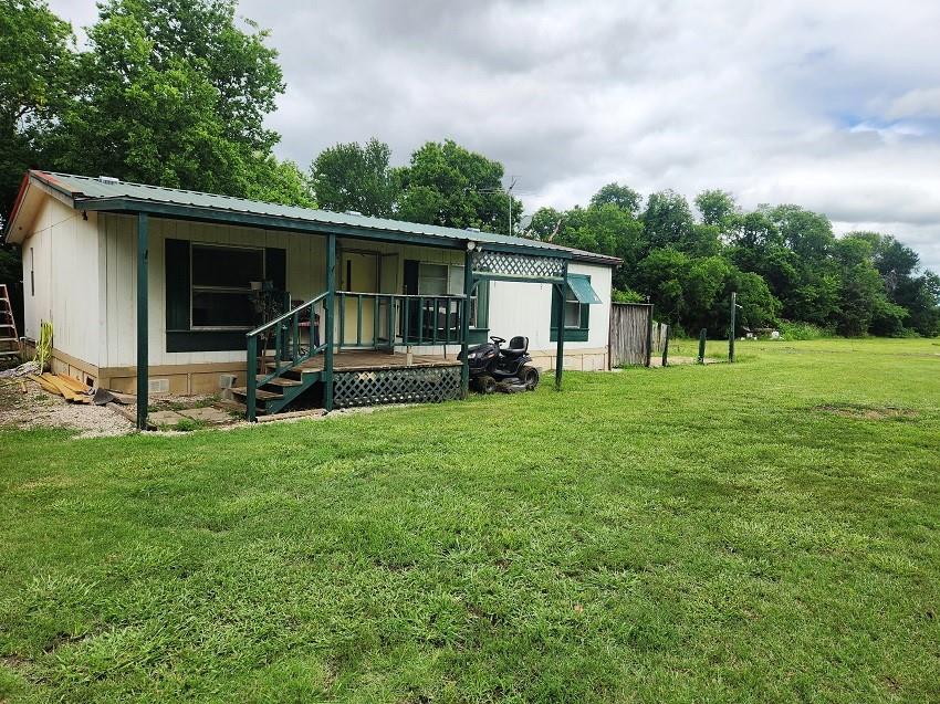 Beautiful 2.054 acres with a 30X50 Shop, concrete floor, engine lift, ceiling is insulated, with electric, 16X8 storage room within. Car port in front of workshop. Attached awning on the side. 1999 Doublewide, 1176 sq ft, 3 bedrooms with 2 baths can be lived in while dream home is built. 12X12X8 out building being built for extra storage. Lots of potential out of the City Limits. Sheep on premises in a large fenced in area. Can go with property sale. No Known Restrictions. Make an Appointment and Come out and take a look around.