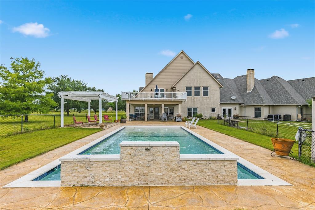 Extraordinary Luxury Estate on 55+ Acres!
Experience luxury country living at its finest in this custom-built 6 bedroom, 4 full bath, 3 half bath estate offering an impressive 6,457 sq. ft. of refined living space nestled on 55+ sprawling acres. This exceptional property combines elegance, comfort, and ranch functionality with two fenced and cross-fenced pastures, two ponds, barn, remote gated entrance, circular drive, and an inground swimming pool.
Step inside through the stunning marble floor entry and discover a home designed for entertaining and everyday luxury. The spacious floor plan showcases two living areas divided by a striking see-through fireplace, a relaxing sunroom, two formal dining areas, and a large chef’s kitchen featuring ceramic tile flooring, industrial-grade vent hood, and abundant prep and storage space.
The luxurious primary suite serves as a private retreat complete with an expansive wraparound ensuite bath, his and hers vanities, oversized walk-in closet, and a private attached office.
The second floor offers exceptional space for family and guests with a spacious game room featuring a half bath, wet bar, and access to a large balcony overlooking the picturesque property. Additional upstairs bedrooms and baths provide plenty of room for comfortable living and entertaining. Additional amenities include a safe room, premium custom finishes throughout, and breathtaking views of the surrounding acreage. Whether you’re seeking a luxury family estate, an entertainer’s dream home, or a beautiful ranch retreat, this one-of-a-kind property offers the perfect blend of privacy, sophistication, recreation, and country charm.