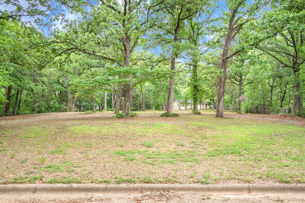Rare opportunity for own the only available residential lot in the established and desirable neighborhood of Woodland Acres. This spacious .56-acre property offers an ideal build site, perfectly elevated to take advantage of its natural surroundings. Mature trees provide a beautiful canopy, and the lot is bordered by woods on one side and across the street, creating a peaceful and private setting. With one neighboring home located at a generous distance, you'll enjoy the seclusion and tranquility rarely found in town.  Whether you're looking to build your dream home or invest in a property in a sought-after location, this lot offers a unique blend of privacy and convenience. Centrally located in Canton, home of the world-famous First Monday Trade Days, and within easy reach of shopping, dining, and schools.  Families will appreciate the highly rated Canton Independent School District, known for its academic excellence and award-winning programs. The natural beauty, established neighborhood setting, and top-tier location make this property a standout choice for anyone looking to build in the heart of Canton.  Don't miss this chance to secure a rare homesite in one of the area's most charming neighborhoods. This lot truly offers the best of both worlds – peaceful surroundings with the conveniences of town just minutes away.