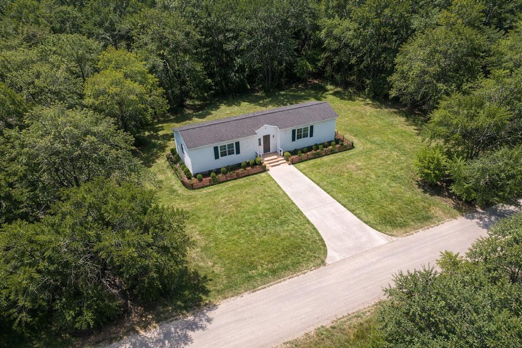 Tucked away in a peaceful, tree lined neighborhood, this lot offers a perfect setting to build your dream home or investment property. Conveniently located just minutes from Lake Granbury with easy access to shopping, dining, and the lake.  ANY Photo's displaying a home are an Artistic Concept and there is no Home on the property. Seller Does Not have blueprints or designs since this is an Artistic Concept of the possibilities that could be possible with this property.