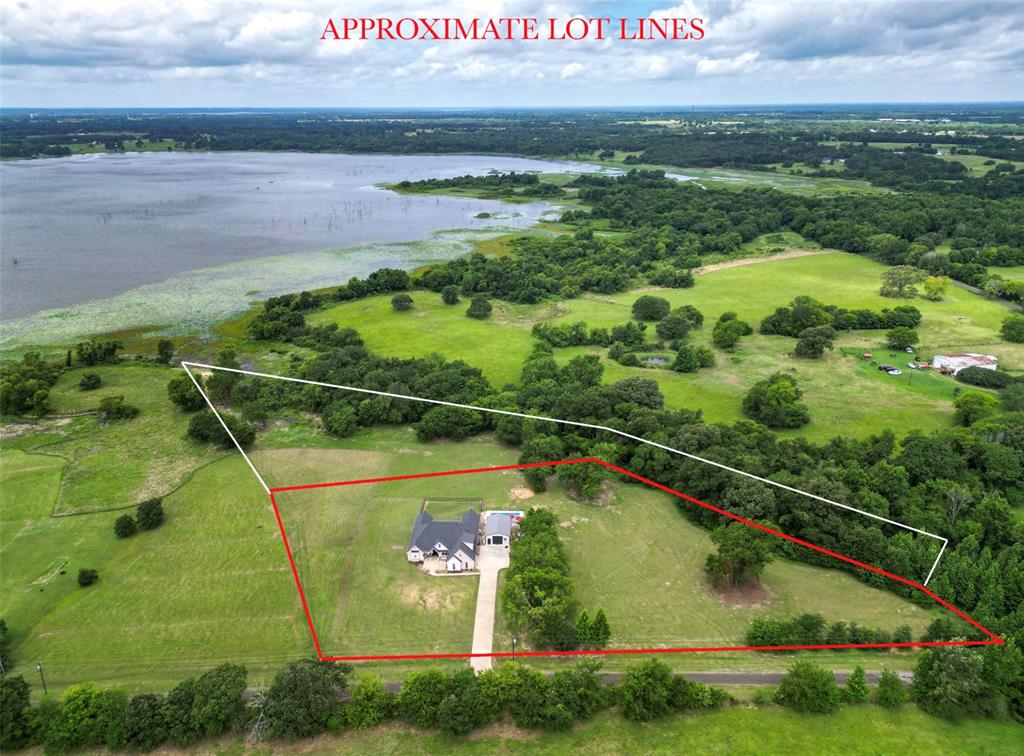 Waterfront living on Lake Fork with 2.84 deeded acres plus 2.28 acres of leaseback! This beautifully designed 4 bedroom, 4.5 bathroom home features soaring 12 foot ceilings, bamboo wood flooring, an open concept layout, and a private sitting room off the primary suite. Every bedroom includes its own full bathroom, offering unmatched comfort and privacy. Outside, enjoy a gunite saltwater pool, breathtaking sunset views, and a 24x26 insulated shop complete with water, electricity, a bathroom, and two 10 foot roll up doors. Additional features include an oversized garage, walk in attic storage, and a mosquito misting system surrounding the home, shop, and pool. The perfect blend of lakefront luxury, space, and functionality.