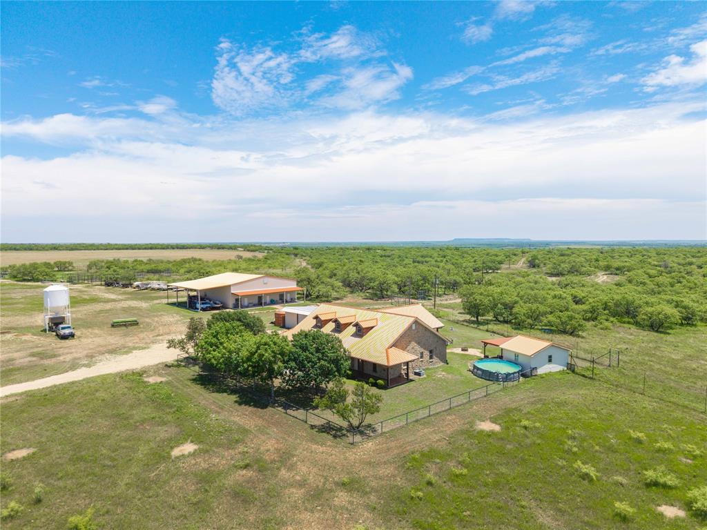 Coleman County High Fence Ranch is an exceptional 418-acre turnkey game ranch located just 6.5 miles south of Coleman, Texas. This highly improved property offers the perfect combination of quality improvements, carefully managed wildlife, productive pastureland, cultivated fields, abundant water, and approximately 60 feet of elevation change with scenic views across the ranch.

The property features a beautiful 2,166 sq ft sandstone home built in 2009 with 3 bedrooms, 2.5 baths, granite countertops, custom cabinetry, spacious dining area, large master suite, wrap-around porch, outdoor kitchen, metal roof, and pipe fencing surrounding the home. Additional improvements include a 3,600 sq ft metal barn with guest quarters featuring 2 bedrooms, 2.5 baths, entertainment room, spray foam insulation, loft, and approximately 1,680 sq ft of covered parking for RVs, boats, vehicles, and equipment. A second 1,060 sq ft metal barn provides additional storage and functionality.

The ranch includes approximately 140 acres of cultivated fields, 120 acres of mesquite pasture, and 158 acres of thick native cover featuring a wet-weather creek, ponds, and outstanding wildlife habitat. Water features include 3 ponds, 2 stocked with catfish, 3 water troughs, and Coleman County SUD water.

Wildlife includes 40+ trophy whitetail deer, 25 red stag, 25 scimitar oryx, 13 blackbuck antelope, 1 axis deer, turkey, dove, bobwhite quail, and waterfowl. The ranch has been lightly hunted and carefully managed to maximize trophy potential.

Additional features include premium Tight-Lock high fencing with predator wire, working pens, holding pen, blinds, feeders, feed trailer, overhead feed bin, generator, and furnishings in the guest quarters. A rare opportunity to own a turnkey hunting and recreational ranch with excellent wildlife, water, infrastructure, and long-term investment potential.