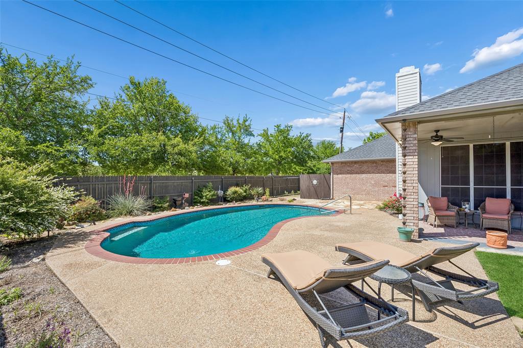 Gorgeous one-story brick ranch-style home set along a beautiful tree-lined street in the distinctive Brooks community, where pride of ownership shines and there is no HOA. This inviting residence blends comfort, style, and functionality, all enhanced by abundant natural light throughout. The heart of the home is the beautifully updated kitchen, featuring an island cooktop, wraparound bar seating, and generous workspace—perfect for both everyday living and entertaining. The open-concept family room is framed by a wall of windows overlooking the backyard, filling the space with light while offering a serene view of the sparkling pool. A floor-to-ceiling brick fireplace serves as a striking focal point, adding warmth and character. The thoughtfully designed split-bedroom layout offers added privacy, with the primary suite situated in its own wing. The en-suite bath has been tastefully updated with modern finishes, creating a relaxing retreat. Secondary bedrooms are well-sized and versatile. Enjoy the backyard oasis, where the pool and well-maintained patio provide an ideal setting for gatherings or quiet relaxation. Additional highlights include a three-car garage with durable epoxy flooring, an extended driveway for additional parking, and a convenient ante-room with plumbing for a sink, offering flexibility for a variety of uses. Located in a peaceful, established neighborhood with convenient access to shopping, dining, and major routes, this home offers both tranquility and accessibility in a truly special setting. 3D tour available online.