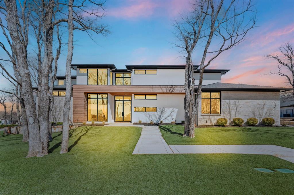 Exquisite Willowtree Custom Home was completed in 2023 and is move-in ready. Stunning and thoughtfully designed transitional modern in privately gated Legacy North on almost a half acre treed lot offers 5 bedrooms, 5 full and 1 half baths, 4 car garage, ensuite bathrooms, 2 utility rooms, downstairs media, office, game room, solid-core doors throughout, luxury engineered white oak flooring, remote controlled window treatments, museum finish walls. Open floor plan welcomes you into a chef’s kitchen complete with Wolf appliance package, built-in refrigerator, seamless white and wood cabinetry, oversized Taj Mahal quartzite island and counters, double convection ovens, drawer microwave, 6 burner range with griddle. Living room features linear fireplace and sliding doors overlooking expansive backyard. Primary bedroom with his-and-hers closets, double shower, soaker tub. Private guest suite down offers huge walk-in shower. Second living down is utilized as a media and offers wet bar, wine fridge, black-out window treatments and sliding door to patio. Upstairs offers 3 bedrooms, game, utility, walk-out attic with huge floored storage, spray foam encapsulated for energy efficiency. The outdoor living area is perfect for entertaining and offers a covered patio area, built-in grill, stone fireplace, infrared heaters, zoysia grass. The electronic privacy screens on the patio offer the perfect blend of indoor-outdoor living, creating an inviting space for hosting gatherings. Plenty of room for pool, pets and play. Four garages with epoxy floors and space for extended parking on driveway. Seller is prepared to offer a reasonable pool allowance if a buyer would prefer a pool. Seller will also pay a year's worth of HOA dues at closing. Gorgeous!
