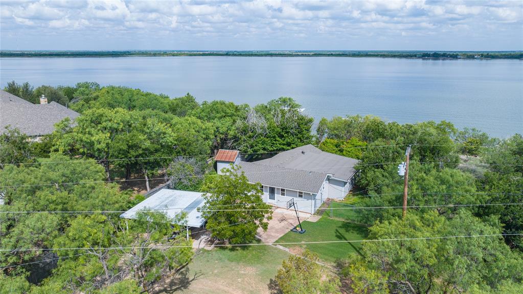 Beautifully updated waterfront retreat situated on a private half-acre lot with gated entry in one of Lake Fort Phantom's most desirable deep-water locations. Whether you're looking for the perfect weekend getaway or a full-time lakefront lifestyle, this property delivers everything you love about lake living. This home offers stunning lake views from multiple vantage points and a warm, inviting atmosphere throughout. The spacious back deck is the perfect place to entertain family and friends, enjoy morning coffee overlooking the water, or unwind while taking in unforgettable Texas sunsets. Call today and make this place your new oasis!