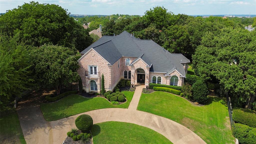 Nestled on an expansive private cul-de-sac lot, this lovely home has it all! Gourmet kitchen featuring Quartzite countertops, double convection ovens, oversized fridge, premium Thermador appliances, soft-close cabinetry, and large island. Wait until you see the views from the house to the backyard, it feels like living in a park! Spacious primary bedroom is on the main level with see-through fireplace and barrel ceiling. Second en-suite bedroom on main level perfect for guests. Upstairs features include large game room with wet bar, large screened porch overlooks gorgeous backyard, a media room and three secondary bedrooms. Loads of closet space throughout. Step outside into a true backyard oasis complete with sparkling pool and spa, stone pizza oven, fire-pit, & sports court for PICKLEBALL all set in a large, private, level yard with lush landscaping. Truly something for everyone. Well provides landscape irrigation. Award winning Carroll ISD, walk to Durham, minutes from Town Square.