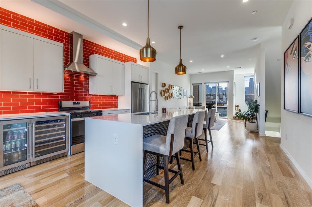 BACK ON MARKET AT NO FAULT TO SELLER! BUYER CHANGED MIND! BRING OFFER! Experience sophisticated urban living in this stunning 3-story contemporary condo, built in 2020. This impeccably maintained 3-bedroom, 2.5-bathroom residence features an open-concept second floor with soaring 14-foot ceilings, oversized windows for abundant natural light, & a private epoxied balcony. The gourmet kitchen is a chef’s dream, boasting quartz waterfall countertops, custom tile backsplashes, premium stainless steel appliances (Whirlpool dishwasher and 20.0 Cu. Ft. KitchenAid Refrigerator), Zephyr 15-inch undercounter beverage center and Zephyr Wine Cooler, walk-in pantry & a gas range. Includes an LG washing machine and LG dryer. The third floor hosts a spacious primary suite with a spa-inspired ensuite featuring dual vanities, professionally wired and installed towel warmer, huge shower, & a walk in closet, along with a secondary guest suite with en-suite bath. Highlights include attached 2-car fully-epoxied garage, MyQ smart garage system, finger-print locks, custom Shade Store blinds throughout w a remotely-operated electronic main shade on 2nd floor, new carpet throughout, front door treated w sunblocking protection, luxury upgrades including a Toto Neorest Washlet and Toto Neorest toilet professionally installed, garage & patio floor epoxied & professionally hardwired Ring security cameras in both front & back of unit. New carpet on the 3rd floor. The third bedroom is on first floor & is versatile office or bedroom. Hot water heater anode rod replaced in Q4 25 & air conditioning capacitor replaced and refrigerant topped up in Q3 25. Located mins from Deep Ellum, Uptown, Lower Greenville and Exall Park. Outside trees provide privacy and bring nature to you w nesting birds; fall colors are spectacular. The HOA covers water, sewer, trash, and exterior maintenance. A true lock-and-leave gem in a premier Dallas location. Walk in, unpack, unwind, entertain and enjoy it all