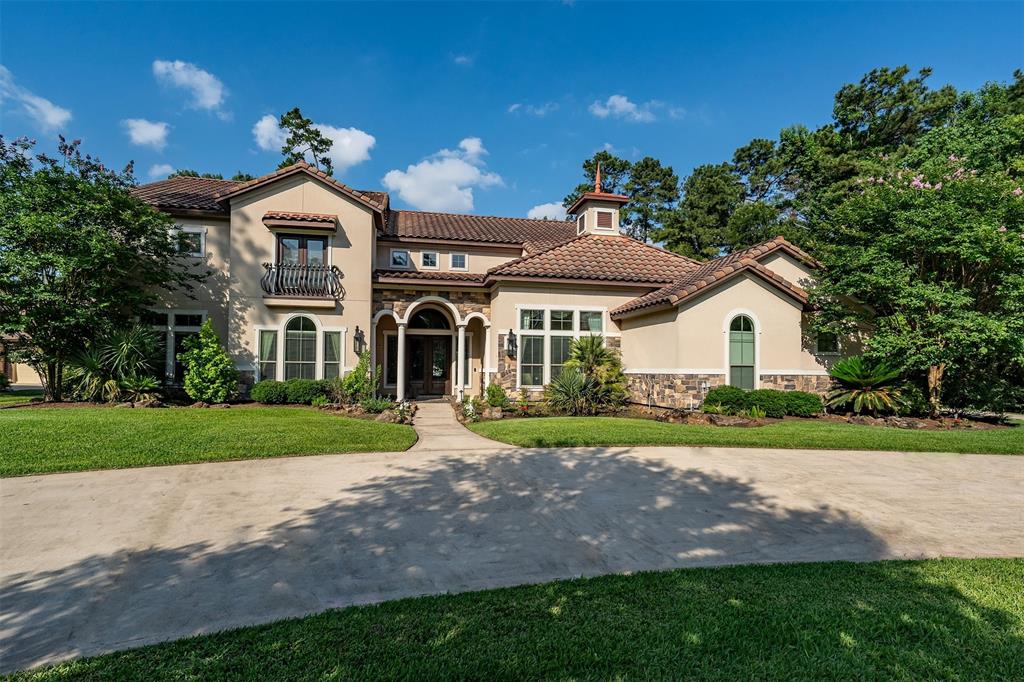 Imagine pulling up to a Spanish Mediterranean architectural design residence nestled within the prestigious Benders Landing Estates in Spring, Texas. This property is a statement of refined living, where luxury blends with tranquility on the lake: 4 bed, 4.5 bath, 2 living rooms, 2 dining rooms, theater, wet bar with wine cellar, custom beach entrance pool, jacuzzi with grotto waterfall. Professional landscaping featuring mature trees and manicured gardens guides you along the circular driveway to a porte cochère or to an attached 3 car garage. Stepping through the impressive entryway, you're greeted by soaring ceilings, fireplace, an abundance of natural light, beautiful pool and lake views. The heart of the home is the gourmet kitchen with SS appliances, custom cabinetry extending to the ceiling, exquisite countertops, spacious pantry and a nearby breakfast nook offers a sun-drenched spot to start the day. The 4 generously sized bedrooms offer private sanctuaries. The primary suite is a true retreat, boasting panoramic lake views, a spa-like ensuite bathroom with a soaking tub, a separate tiled shower with multiple showerheads, dual vanities and expansive walk-in closets. The additional 3 bedrooms are equally well-appointed providing comfort and privacy. Multiple living spaces cater to both formal entertaining and casual relaxation. However, the true allure of this property extends beyond the interior. Step outside to your own private oasis. An outdoor kitchen complete with built-in grill sets the stage for al fresco dining. Enjoy the tranquility of the water, whether it's fishing, kayaking, or simply appreciating natural. Living in Benders Landing Estates adds another layer of exclusivity: this sought-after community is known for its large, estate-sized lots, mature trees, and sense of privacy. It's more than just a home; it's a legacy property.
