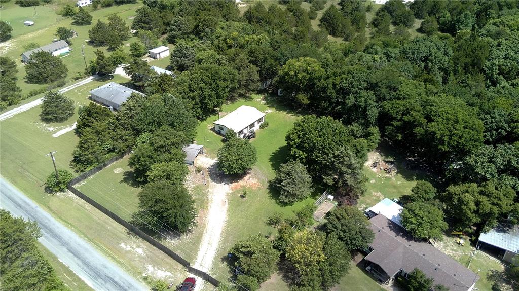 Welcome to your own slice of country paradise! Nestled among beautiful mature trees, this charming property offers the perfect blend of privacy, functionality, and peaceful living. The fully fenced property provides plenty of room for pets, livestock, gardening, or simply enjoying the outdoors.

Designed for those seeking a rural lifestyle without sacrificing convenience, the property includes two storage areas, and a covered parking area. Its ideal for hobby farming, homesteading, or enjoying fresh eggs right from your backyard. Relax under the shade of the mature trees, enjoy the open space, and embrace the peaceful setting this property offers.

Located within the highly regarded Tom Bean ISD, this property combines the benefits of country living with access to a strong community and excellent schools. Whether you're looking for a place to raise a family, start a hobby farm, or simply enjoy a quieter way of life, this property offers endless possibilities.

Conveniently located just minutes from Sherman, you'll enjoy easy access to shopping, dining, and major highways while still having the privacy and tranquility of a rural setting.