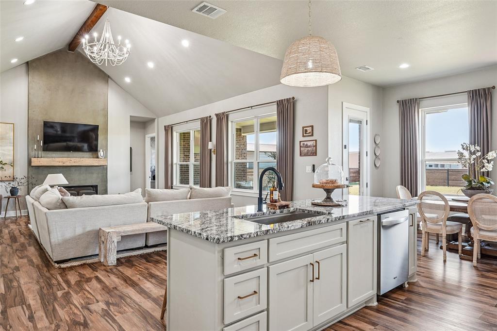 Immaculately maintained and newly built in 2024, this stunning home is tucked away in an established, active neighborhood in Muenster, Texas — home of the Muenster Hornets and Sacred Heart Tigers. Located off the main roads, the neighborhood is known for pride of ownership, beautiful yards, and a welcoming community atmosphere. This 4-bedroom, 2.5-bath home with a 2-car garage offers an open-concept layout designed for both comfort and entertaining. Vaulted ceiling in the living area and 10-foot ceilings throughout create a spacious, airy feel. The oversized kitchen island keeps the chef connected to family and guests, while the impressive butler’s pantry adds exceptional storage and functionality.
Two secondary bedrooms are connected by a thoughtfully designed Jack-and-Jill bathroom featuring private sinks and individual closets. A fourth bedroom could serve as an office or bonus room. The luxurious primary suite is a true retreat, complete with a spa-like bathroom featuring a separate shower, standalone soaking tub, and a large walk-in closet with floor-to-ceiling shelving. Unwind in the evenings on the covered back porch overlooking one of the few sunset views of Muenster Lake, all within the privacy of a metal frame wood privacy fence. Situated on over half an acre, the property offers plenty of room to add a shop, pool, or additional outdoor living space. This move-in-ready home combines modern design, quality craftsmanship, and small-town charm in one exceptional property. Information deemed reliable but to be verified by buyer and agent.