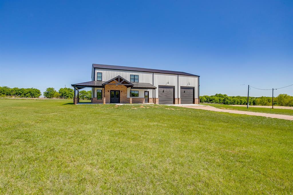 This stunning 5-bedroom, 4.5-bath barndominium set on 1.41 acres of serene countryside. This thoughtfully designed home combines modern comfort with country charm, offering an inviting open-concept layout perfect for everyday living and entertaining. Soaring ceilings, abundant natural light, and spacious living and dining areas create a warm, airy atmosphere throughout.

The beautifully appointed kitchen features generous counter space and seamless flow into the living area, making it ideal for gatherings. The primary suite is a peaceful retreat with a luxurious, spa-inspired bathroom, while additional bedrooms and bathrooms provide ample comfort for family or guests. A versatile bonus space can serve as a game room, office, or home gym.

Outside, the barndominium design delivers impressive storage, workspace, and room to enjoy the wide-open 1.41-acre setting. Whether you're looking for space to spread out, work on projects, or simply take in the views, this property has it all. Drive-thru roll up garage with spray foam insulation. 

A unique blend of style, space, and country living — don’t miss the opportunity to make this exceptional home yours.