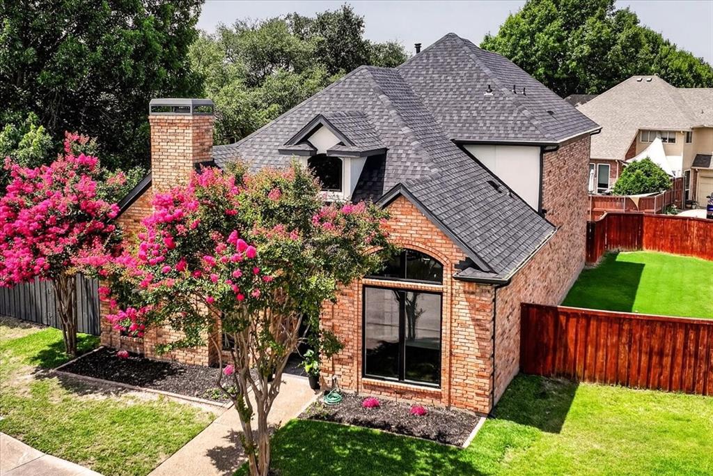 This Stunning corner lot home is located in the highly sought after award-winning Plano West Senior High School. Positioned directly across from a beautiful picturesque neighborhood park & views right from your front door. No detail has been overlooked in this thoughtfully renovated residence. The modern exterior showcases new large windows, a fresh roof, updated paint & elegant slate tiled front entry & also covered back patio area. Step inside to an inviting open floor plan filled with natural light. A private study off the entry features painted wood accent wall & french doors. The living room impresses with sleek modern tile, wood mantle, dramatic black custom painted fireplace to ceiling with striking black celling beams. The gourmet kitchen is a standout, featuring a waterfall quartz peninsula, white & natural wood cabinetry combination, and a custom vent hood. Top-of-the-line KitchenAid appliances, a pantry with roll-out custom shelving, & floating shelves complete the modern appeal. The adjacent dining area is enhanced by a beautiful gold light chandelier, while a versatile wine bar with a beverage fridge & wine rack adds convenience for entertaining. The first-floor primary suite offers abundant natural light from patio & backyard windows. The dreamy primary bathroom includes a modern freestanding tub, rainfall shower with pebble tiles, dual sinks, ample storage cabinetry & a huge closet accessible through sliding glass doors. A powder bath with style and spacious laundry room. Upstairs, you’ll find 3 additional bedrooms, a full bathroom & versatile flex space perfect for a game room, office, or study. Outside, enjoy towering mature trees with a nicely groomed backyard & the covered patio perfect for for entertaining or relaxing. EV charger ready. This prime location puts shopping, dining & everyday conveniences right at your fingertips. Move-in ready home perfectly blends modern style with comfortable living in one of Plano’s most desirable neighborhoods.