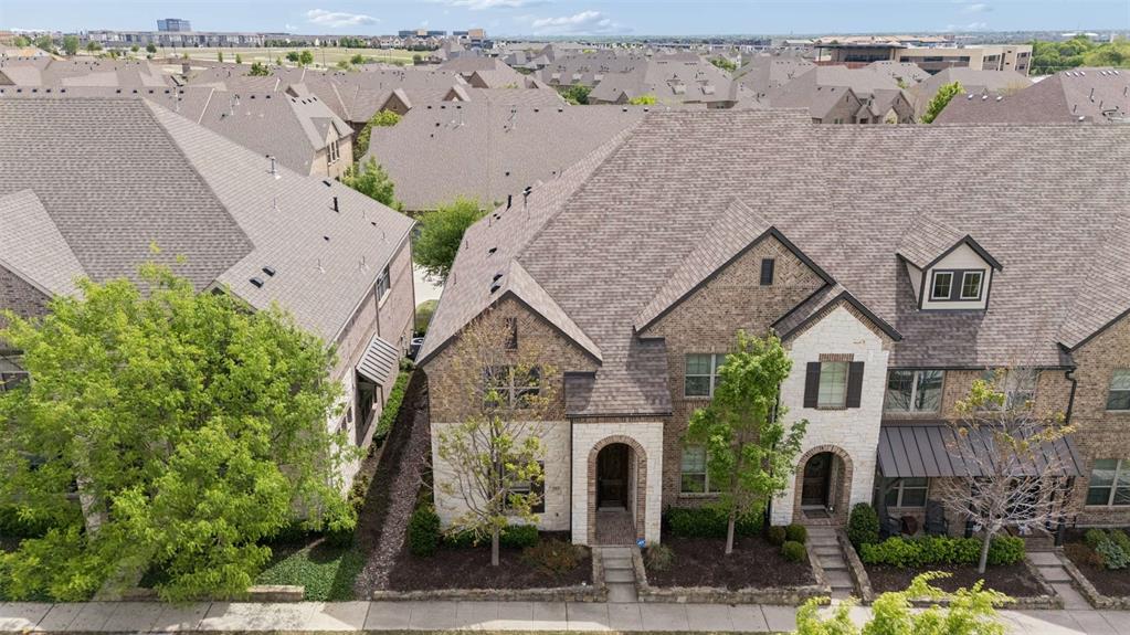 Positioned as a premium end-unit in The Greens at Stacy Crossing, 7213 Huckleberry offers a refined blend of natural light, thoughtful updates, and low-maintenance living in the heart of McKinney, zoned to highly acclaimed Frisco ISD. With three bedrooms, two full baths, and a powder bath, the layout is both functional and elevated, designed for effortless everyday living, entertaining, and a true lock-and-go lifestyle. Freshly updated with paint throughout, including walls, doors, and trim, the home also features a newly installed tankless water heater, microwave, washer and dryer, and includes a refrigerator. Wood floors run throughout the main living areas, where tall ceilings and beautiful windows create a bright, inviting atmosphere across the open-concept living and dining spaces. The gourmet kitchen showcases shaker-style white cabinetry, a center island, granite countertops, a trash pullout, and stainless-steel appliances, including a four-burner cooktop and single oven. A dedicated bonus nook adds flexibility for remote work, while the powder bath and under-stair storage enhance everyday convenience. Upstairs, the primary suite serves as a private retreat, highlighted by a vaulted ceiling and a beautifully appointed ensuite bath featuring quartz countertops, separate vanities, a sitting area, an oversized shower with bench, linen storage, and an expansive walk-in closet. A game room offers additional living flexibility, complemented by two secondary bedrooms and a well-appointed full bath with quartz finishes and a tub-shower combination. Residents enjoy access to a community pool and clubhouse, while HOA-covered exterior maintenance supports a true low-maintenance, lock-and-leave lifestyle and contributes to lower insurance costs. Ideally located with quick access to Highway 121 and US 75, this home is moments from shopping, dining, schools, and parks, offering a seamless blend of comfort, style, and convenience.