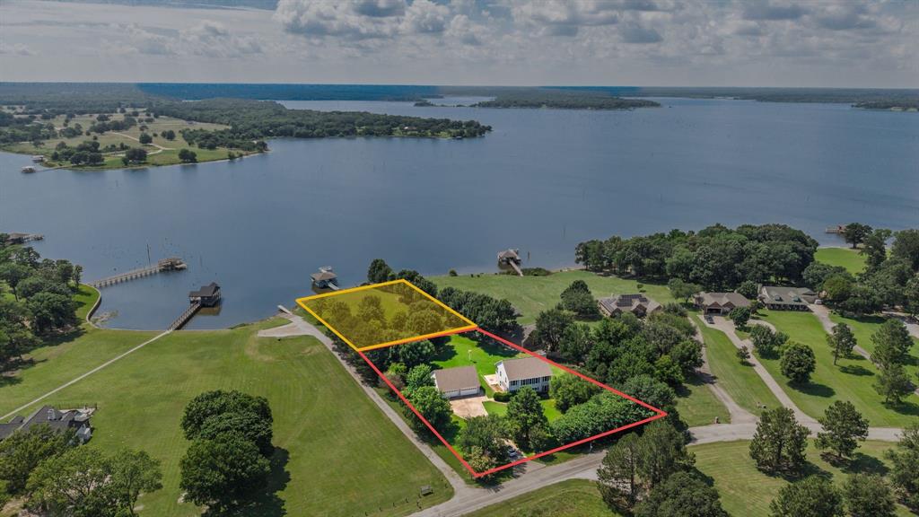 Waterfront on Lake Fork with a large dock, right next to the neighborhood boat ramp, so you have that too!  House needs some updating but it has good bones!  4 Car garage!  Very nice quiet neighborhood where the neighbors all know and watch out for each other.  The 2nd floor is where all the bedrooms is, and 2 of them have access to a screened in balcony that overlooks the lake.  The primary has a very large bath and closet.  There is even a sauna in the bathroom.  Come take a look and see how great Lake Life can be!