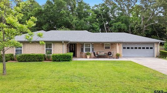 Located in the highly south-after Whitehouse ISD, this beautifully upgrades home offers both comfort and style. A spacious covered front porch provides a warm welcome and the perfect spot to relax. Inside, you'll find polished ceramic tile flooring, vaulted ceilings, and a cozy wood burning fireplace that anchors the main living area. Glass doors lead to a covered patio ideal for entertaining, complete with charming party lights for evening gatherings, The kitchen is a standout, featuring granite countertops and a premium LG drop-in stove with convection oven and air fryer, highlighted by a striking deep blue interior. The LG French-door refrigerator with pull-out freezer will remain with the home. The primary suite offers a private retreat with two closets and an ensuite bath. Secondary bedrooms share a well-appointed hall bathroom, making the layout both functional and inviting. Step outside to enjoy a spacious, private backyard with a large storage building; perfect for tools, hobbies, or just extra storage. Double pane windows throughout and energy efficiency and comfort. Don't miss your opportunity to see this exceptional home. Please schedule your private tour today!