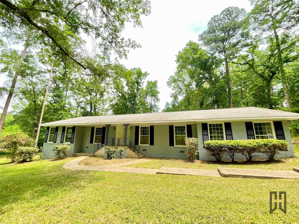 Welcome Home to this beautifully updated 3 bedroom, 2 bathroom home nestled on just over 1 acre inside the city limits, yet offering the peaceful feeling of country living. Surrounded by mature trees and situated on a gorgeous oversized lot, this property provides the perfect blend of privacy, space, and convenience. Step inside to discover fresh paint, abundant natural light, and a warm, inviting layout designed for both everyday living and entertaining. The updated kitchen is a standout feature with granite countertops, custom cabinetry, ample prep space, and a spacious walk-in pantry. Just off the kitchen, the oversized laundry room offers incredible storage options with built-in cabinetry and room for organization. The home features an elegant formal living room with a cozy fireplace and beautiful hardwood flooring, while the massive family room provides endless possibilities for gatherings, game nights, media space, or a second living area. Built-in shelving adds charm and functionality to the oversized space.
The spacious primary suite offers a relaxing retreat complete with a beautifully updated ensuite bathroom featuring dual vanities and a custom tiled walk-in shower. All bedrooms are generously sized with large windows that fill the home with natural light. Additional highlights include double-pane windows, classic brick construction with vinyl siding accents, updated finishes throughout, and timeless curb appeal. If you are searching for space, comfort, storage, and a peaceful setting with room to spread out, this beautiful Beverly Drive property is one you do not want to miss. Schedule your private showing today!