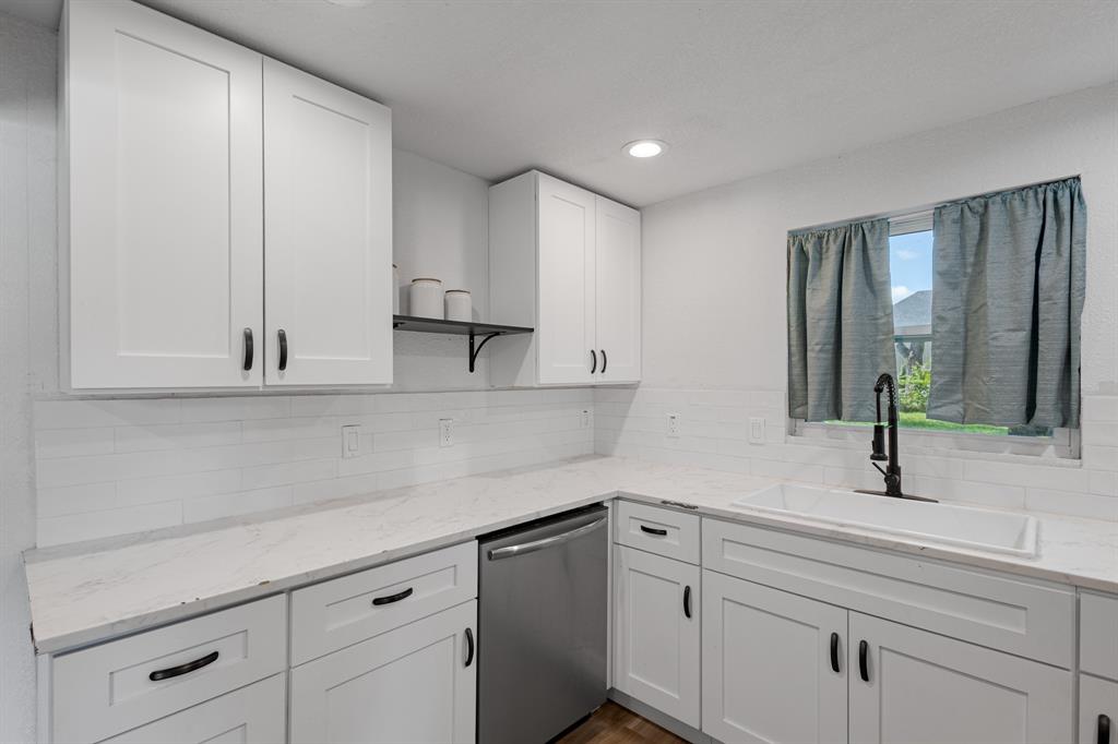 Step inside this charming 3 bedroom, 2 bath home located just minutes from Bridgeport High School in a neighborhood where homes feel like they could tell a story. The layout keeps the main living areas connected and appears larger than its approximate 1,094 square ft footprint. The kitchen offers modern upgrades with white cabinetry, marble-style Formica countertops, a white deep sink with dark accents, and stainless steel appliances including an electric stove and dishwasher. From the kitchen sink, a window frames views of the backyard, bringing light and a sense of openness into the space. The dining area sits just off the kitchen, positioned beside double French patio doors that open to the wooden patio. The glass panels bring in natural light and visually extend the space outdoors without interrupting the interior flow. The wooden patio wraps partially around the side of the home and functions as an extended outdoor living area for everyday use or gatherings. A partial chain-link fence outlines the yard, complemented by mature trees that add shade and depth. 2025 Updates- New Roof • New Foundation (approx. 18-inch lift completed) • New Plumbing – Water Lines & Drain Lines • New Electrical Wiring • New Windows • Spray Foam Encapsulation – Ceilings & Walls • New Wood Patio. A comprehensive renovation where no detail was overlooked. This home offers curated updates, the appeal of modern finishes, and the peace of mind that comes with a fully renewed home.