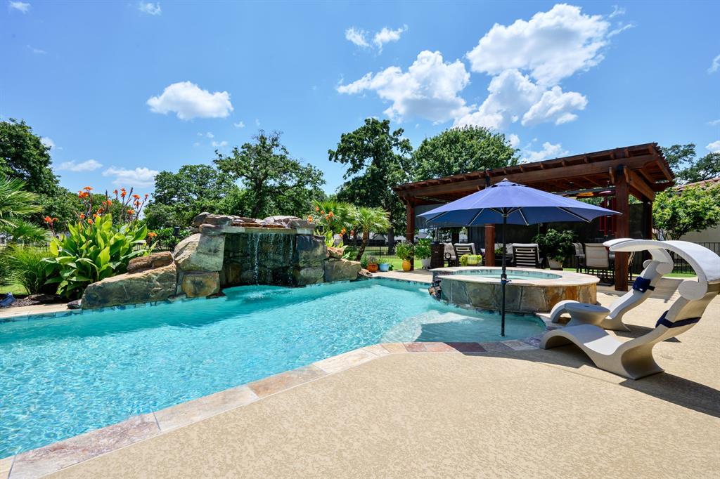Tucked inside the coveted Catalina Bay waterfront community, this four-bedroom, two-bathroom retreat proves that pride of ownership shines through in every thoughtful detail. From the moment you arrive, the extensive landscaping sets an elegant tone that continues well beyond the front door. Inside, engineered hardwood floors stretch beneath vaulted ceilings crowned with rustic wood beams, striking that perfect balance between refined and welcoming. The heart of the home is a true chef's kitchen, outfitted with brand-new high-end appliances that make weeknight dinners feel gourmet and weekend gatherings effortless. Whether you are simmering something special or simply pouring a glass of wine, this space rises to the occasion. The primary bedroom serves as a private sanctuary, complete with an en-suite bathroom and his and hers walk-in closets so generous they might just spark a wardrobe upgrade. Three additional bedrooms offer flexible room for family, guests, or that home office you keep promising yourself. Large oversized garage with room for a golf cart! Step outside and prepare to be smitten. The backyard is a genuine oasis, featuring a sparkling pool built in 2022, a bubbling hot tub, cool decking and a cabana pergola built for lazy afternoons and lively celebrations alike. Best of all, you can enjoy every bit of it without baking in the relentless Texas western sun. Backing to the community greenbelt, the property invites endless walking, jogging, and fresh-air adventures right out your back gate. Worry free stucco was redone new in 2024.