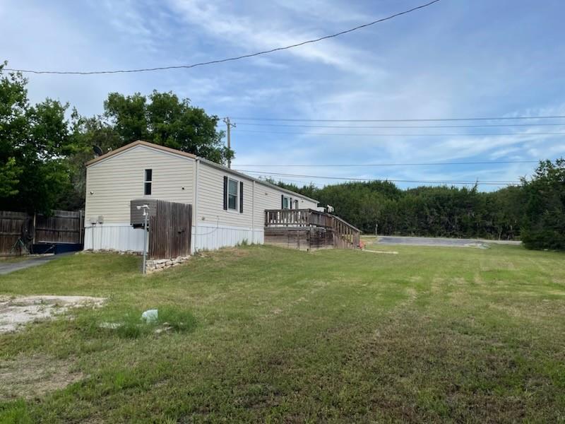Lake community home on 3 lots, live-in ready! HOA has boat ramps 5 minutes from the home at 2 different locations. Plenty of room to park your boat or RV, with a full RV hookup, 50-amp plug-in & septic. Home last updated in 2025, including new vinyl plank flooring. New metal roof has been installed. Kitchen has a breakfast bar, all new stainless-steel appliances, new large sink & new faucet.  New low-E Energy Star, lifetime warranty windows, keep your home cool in the summer & warm in the winter. Master bath completely remodeled in 2024, with a walk-in shower, granite vanity top, new sink & new fixtures; extra shower wall tiles are in the 24x14 storage bldg, powered by solar energy. Guest bath received a new vanity, new sink & new faucet last yr.  Seller is willing to convey the following list of items: Washer and dryer, as well as some of the added cabinetry in the laundry area and in the master bath; inside fridge; outdoor freezer, which has a warranty & back-up solar power; home security equipment; wooden hutch against kitchen wall (see photo); & outdoor gas grill. Front parking is newly paved, as well as the driveway at the back of the property. There is an extra-long 24x12 ft carport for a truck or trailer. Front decking was extended to 18x10 ft with additional decking at the back as well. The storm shelter is clean and in good condition. The home & grounds have been very well maintained by the current owner who has thought of everything. The HOA also has 2 different playground locations & 2 different picnic area locations. There is a survey.