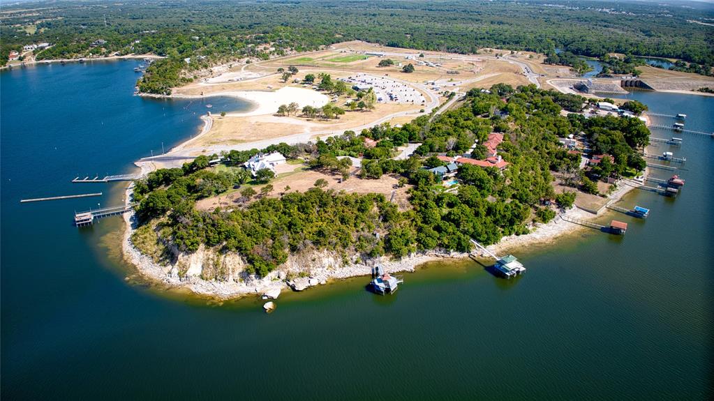 RECENTLY REPLATTED INTO ONE LOT. WILLING TO DIVIDE INTO TWO LOTS 1.8M EACH. This property sits atop one of the highest points of the lake offering breathtaking 300-degree views that stretch for miles, granting you an unparalleled experience like no other. Not only is this property at one of the highest points but it is also at one of the deepest parts of the lake, in close proximity to the dam. Whether you're seeking the thrill of reeling in the day's catch or yearning for exhilarating adventures on the water, Lake Eagle Mountain is an aquatic playground! On one side the property has a double-decker dock where you can relax and immerse yourself in the tranquil ambiance. Don't miss out on this remarkable waterfront property!