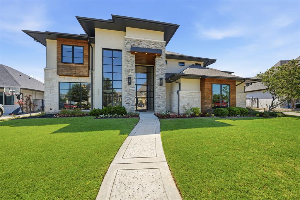 Some homes check boxes. 913 Rhone Lane rewrites the list. Built by Elizabeth Ryan and finished with the kind of intentional upgrades that only happen when the owners genuinely love where they live, this is the one buyers describe to their friends immediately after the showing.
Carillon is the kind of neighborhood that earns loyalty. A lake, a walking path, quiet streets, and a location on the hospital power grid so you are never the person posting about lost power on the neighborhood app.
Inside, wide-plank hardwood floors run warm through the main level toward floor-to-ceiling windows that hold the backyard in full view. An illuminated floating staircase, a statement fireplace feature wall, tray ceilings with cove lighting, and a $75,000 whole-home AV and Lutron automation package, nine zones of in-wall speakers, integrated mesh WiFi, and motorized shades. What does all of that mean? It means everything works exactly the way you want it to from day one.
The Thermador kitchen is built for the cook who means it: 6-burner gas range with griddle, double oven, gourmet coffee bar, and a walk-in pantry. A dedicated media room, entertainer's bar with wine refrigeration, and a private guest suite with en-suite bath round out the interior.
Step outside and the covered patio screens lower at the touch of a button, opening to a pool and spa, 12-foot gas fire pit, and a fully equipped outdoor kitchen. This is the backyard your guests will talk about on the way home. 
Zoned to the highly acclaimed Carroll ISD, with Southlake Town Square and Grapevine Lake both just minutes from your front door. This is the location buyers wait for.
These sellers are not leaving because the home failed them.
They just want the next chapter of your life to begin here.