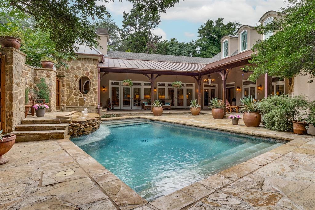 This French country residence graces a premier block of Kessler Park. With over 5,000 square feet of pristine interior space, it boasts clean lines and exceptional craftsmanship. The living room, owner retreat, kitchen, and family room exude warmth with fireplaces and overlook the spectacular courtyard. A culinary masterpiece awaits in the chef's kitchen, with top-of-the-line appliances seamlessly connecting to the living room and breakfast area. The large primary suite boasts a sitting area, an indulgent bath retreat with dual vanities & a light-filled shower, and a soaking tub. 4 additional bedrooms, a Spacious office, and a spectacular home theater room set this home apart from all others. Other features include a recently installed roof, which includes an extensive copper portion, a saline pool and spa, a 3-car garage, four fireplaces, Wood flooring, designer lighting, raised ceiling heights, and Kessler's finest location. An exceptional home for entertaining and gracious living.