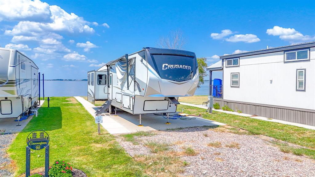 Premimum Lot 97 located in Peninsula Point on the shores of Richland Chambers Lake. If fishing is your thing, this could be your spot.  Excellent location for fishing or relaxing. Waking up to sunrises over the water, getting out on the water for fishing & boating all day, & then coming back for a recharge as you sit by the waters edge under the pergola watching the amazing sunsets! The water tap fee is already paid to keep some extra money in your pocket too! Lot has expanded concert pad and sidewalk to the water as well as a pergola. Peninsula Point features great community amenities like a sparkling pool for hot summer days, an open air clubhouse, laundry facility, boat storage, boat ramp & even more! This lot features a steel retaining wall for an easy tie up for your boat. The lake is great for fishing, boating, jet skis and more. Just 65 minutes from Dallas. This community is short term rental friendly, so you can rent out your new purchase for an income stream! Lot is approved for tiny house.  Must verify.  List price doesn't include RV.  See the uploaded documents for more info.