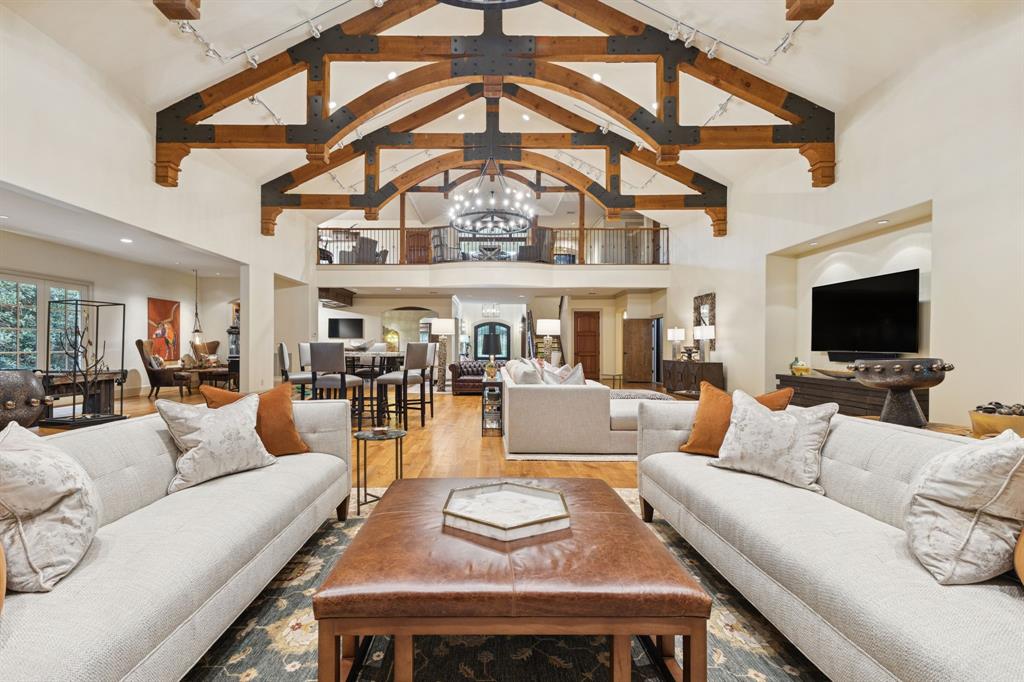 Welcome to a rare opportunity to own unmatched luxury in the prestigious, guard-gated Cottonwood Valley golf community in Las Colinas. Perfectly situated on the 11th Fairway, this residence combines architectural elegance, thoughtful design & more than $350K in updates.
Custom-built home, originally crafted by a builder as his personal residence, showcases scale & finishes of the highest quality. The flexible layout includes 5 ensuite bedrooms with 2 full primary suites one on the main level and a private guest suite with separate entrance, full kitchen, & bath, ideal for multi-generational living or staff quarters. A residential elevator ensures easy access across all levels.
At the heart of the home, a dramatic 2,500 sq. ft. great room features soaring ceilings with exposed beams, Austin stone fireplace, warm wood floors, game area & full wet bar—one of three in the home. The chef’s kitchen boasts professional appliances, granite island, custom cabinetry & a sunlit breakfast nook. Dual offices provide work-from-home flexibility.
The main-floor primary suite offers a true retreat with dual spa baths, 2 oversized closets, sitting area & patio access. Upstairs, a second primary suite features vaulted ceilings, walk-in shower & nearby living area with wet bar. The lower level includes game & media spaces, 2 guest suites with golf course views, and walk-out access to outdoor living.
Enjoy multiple covered patios with motorized shades, stone firepit area, water feature, and room for a pool, all framed by lush landscaping. Additional highlights: 3 car garage with pull-through bay, standing seam metal roof, Control4 smart system, upgraded lighting, mosquito mist system, & security cameras.
Resort-style living continues just steps away at the Nelson Sports Club with golf, tennis, fitness, dining, and swimming. Conveniently located minutes from DFW, Love Field, Toyota Music Factory, and premier shopping & dining. A crown jewel in Cottonwood Valley.