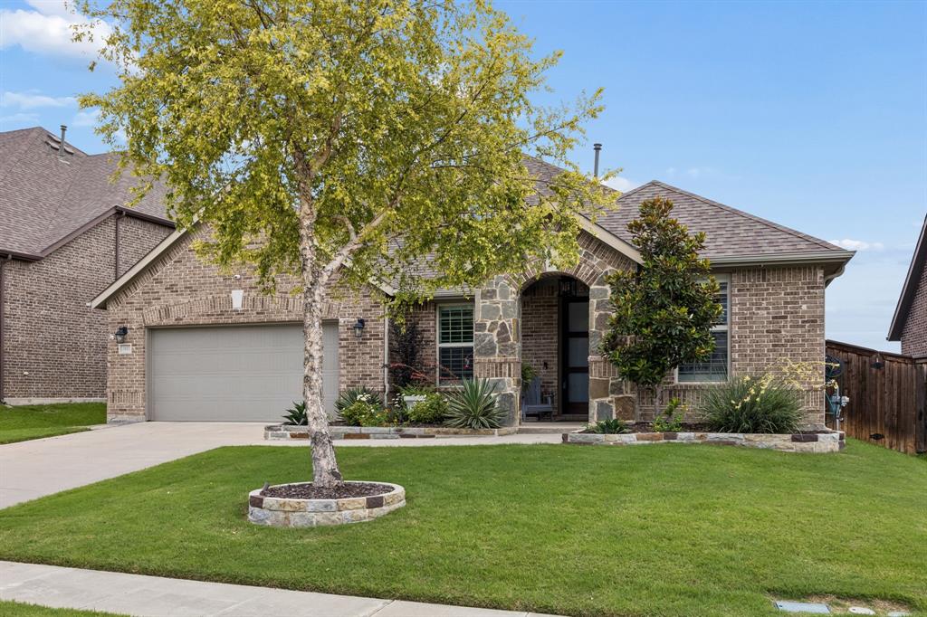 Classy and meticulously maintained, this 1.5-story Trinity Falls home is guaranteed to steal your heart. It pairs designer upgrades with a private backyard escape made for Texas summers. Inside, rich wood floors run throughout the first floor, complemented by updated lighting and a dining room dressed in a coffered trey ceiling and adorned with custom built-ins. The kitchen is the true centerpiece, showcasing crisp white cabinetry embellished with nickel hardware, a spacious island with a stainless sink, quartz perimeter counters, stainless appliances, a gas cooktop, a wine fridge, and a glass-tile backsplash that ties the palette together. A floor-to-ceiling stone fireplace anchors the open living area, where walls of plantation-shuttered windows frame the sparkling pool just beyond. The peaceful primary suite invites you to enjoy dual vanities, a walk-in shower, and a generous closet. The home office with French doors offers a quiet place to focus, while the versatile 4th bedroom upstairs makes an ideal gym, media room, or guest retreat. Step outside to a covered patio overlooking a refreshing pool, paver decking, and lush, low-maintenance xeriscape wrapped by a privacy fence. The 3-car tandem garage is outfitted with epoxy flooring, EV charger, and ample built-in storage. Living in Trinity Falls means a genuine sense of belonging. This 2,000-acre master-planned community delivers resort-style pools, a fitness center, over 20 miles of trails, lakes, a dog park, and 450 acres of green space. The newest amenity center features co-work areas, an event lawn, and gathering space with a catering kitchen. An on-site elementary, full-time lifestyle director, and year-round activities keep neighbors connected, while quick access to US-75 and Highway 380, plus the nearby HEB, puts shopping, dining, and the commute within easy reach. Coveted pool homes like this rarely last long. Schedule your private tour today — this home will certainly make the top of your list!