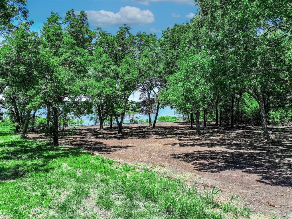 Grab this rare 1.23 acre waterfront lot with an estimated 190 feet of lake line on the quiet shores of Lake Tawakoni and step into one of the most peaceful settings the lake has to offer. This park like property sits inside the gated Rocky Ford Addition, giving you the perfect blend of privacy, natural beauty, and community amenities. It is the ideal canvas to build your dream residence or weekend escape.

The subdivision features a refreshing swimming pool, tennis and pickleball courts, a private boat ramp, a charming fishing pier, and a shaded picnic area. Whether you envision mornings on the water, afternoons exploring the outdoors, or evenings unwinding under the trees, this lot delivers the lifestyle so many buyers are searching for.

Located on the east side of Lake Tawakoni in Lone Oak, you are just an hour east of Dallas and only twenty minutes south of Greenville. The gated entrance, quiet surroundings, and well maintained community create a serene and secure environment for your future home. Sabine River Authority governs these lots, including requirements for septic placement. Electric is on site and water is provided through Cash Water SUD.

Do not let this opportunity pass you by. Secure your piece of Lake Tawakoni and start creating the lakefront haven and dreams you have always imagined.