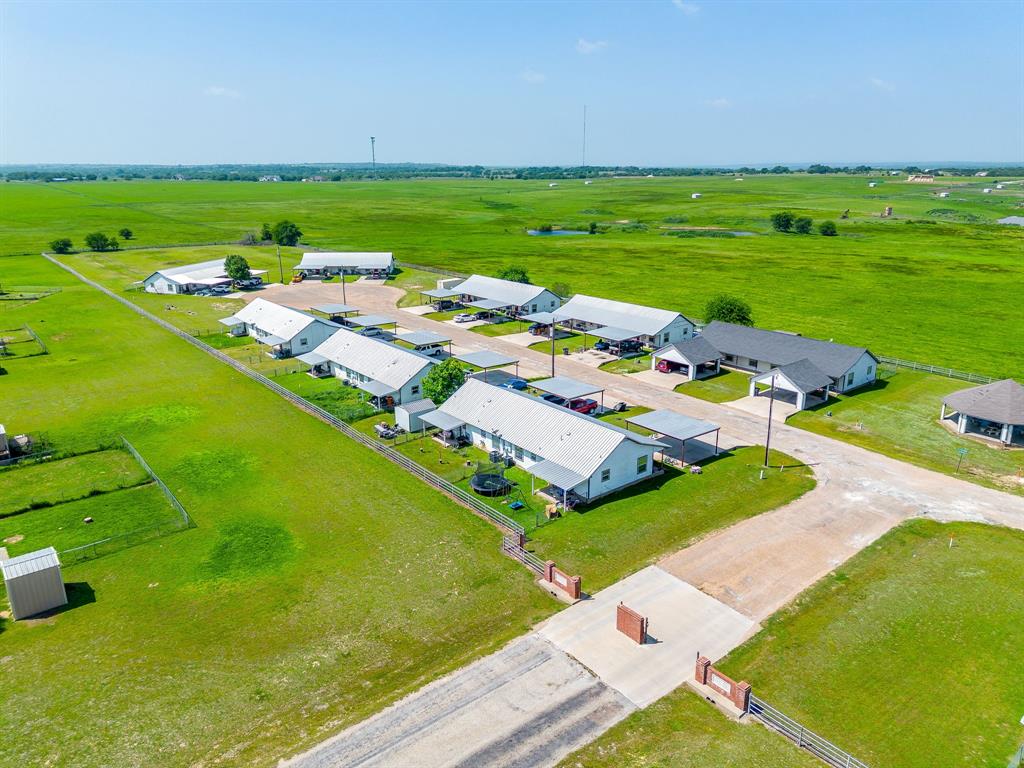 This is a prime investment.  Located in South Blue Meadows, this sale includes 7 buildings, 14 total units, and 2 commercial aerobic systems on a combined 3.61 acres of land with a 20 foot connex storage container.  Excellent cash flow, many long term tenants, and very low turn-over.  Each unit is 3 bedrooms and 2 bathrooms, all electric, large open spaces, vaulted ceilings in kitchen, and the dining-living room combo has a pantry and washer-dryer hook-ups.  There are 2 large bedrooms with shelved closets and 1 main bedroom with a walk-in closet with built-in shelves and an ensuite bathroom.  The back porches have metal canopies and large dividing chain link fences for each unit.  This complex is located on the last street of the subdivision with an inviting brick pillar entrance.  The community has a highly sought out small town atmosphere, and is located in acclaimed Peaster ISD.