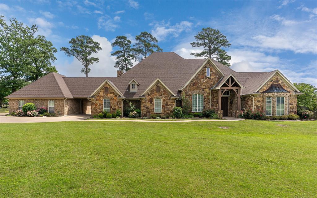 Stunning golf course home located in sought-after Gilmer ISD, offering exceptional design and an ideal layout for both everyday
living and entertaining. This beautifully maintained property features 4 spacious bedrooms, 3.5 bathrooms, and sits on nearly
¾ of an acre with scenic views of the Gilmer Country Club golf course. Step inside to an open-concept living, kitchen, and
dining area highlighted by soaring 12-foot ceilings, rich hardwood flooring, and elegant travertine in the main living spaces. The
custom kitchen is a true centerpiece, complete with abundant cabinetry, generous counter space, a large island, and stainless
steel appliances. A separate wet bar adds convenience and is perfect for hosting. Each bedroom is generously sized and
thoughtfully positioned for privacy. A dedicated home office with built-ins sits just off the entry, ideal for working from home.
The primary suite offers peaceful backyard views and features a luxurious ensuite bath with a soaking tub, walk-in shower, and
an oversized walk-in closet. Outdoors, enjoy your own private retreat with a large covered patio and a gunite pool featuring a
waterfall and grotto—perfect for relaxing or entertaining guests. All bedrooms are located on the main level, while upstairs
you’ll find an expansive game room and a covered balcony overlooking the backyard, golf course, and surrounding landscape.
This home truly has it all—space, style, and incredible amenities—making it perfect for those who love to entertain or simply
enjoy refined living. Schedule your private showing today!