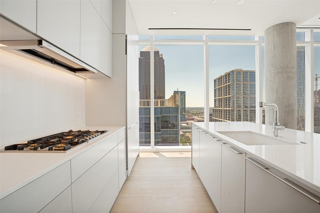 Upon arrival, one is welcomed by the iconic Dallas skyline in this newly constructed home within the Masterpiece Collection. Artfully designed it sets the tone for urban sophistication. With 3-bedrooms and 3.5 baths this home offers a rare opportunity to reside in Dallas’s most luxurious and exclusive high-rise in the heart of the Dallas Arts District and Klyde Warren Park. White oak hardwood 7” plank floors throughout the home,
gracious 11’ ceilings with floor-to-ceiling windows and electric Lutron shades provide a front-row seat to sweeping views. Featuring the highest quality finishes, including a custom bulthaup kitchen, two butlers’ pantries, Gaggenau appliances and Dornbracht fixtures. The sequestered primary bedroom features a spa inspired bathroom showcasing a “Tea-for-Two” Kohler bathtub, dual sinks, built in medicine cabinets an oversized walk-in
closet. Amenities include on-site concierge services, 24-7 valet, house car service, private wine storage, fitness studio, dog spa and serene treatment room. The resort-style infinity edge lap pool, putting green, gas grill and fire pits create an outdoor oasis. HALL Arts Residences is Gold LEED rated and prioritizes health as a WELL Certified residence.