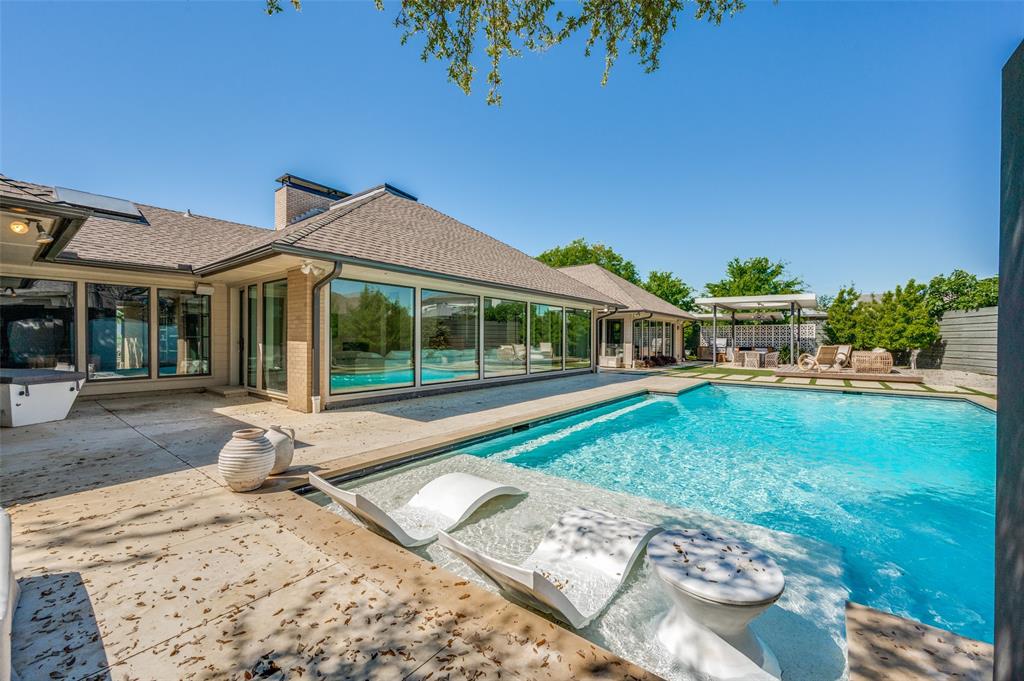 This stunning property offers both beautiful indoor and outdoor spaces, perfect for entertaining. The spacious living area features tall ceilings and skylights, bathing the room in natural light. Large windows provide views of the private, tranquil outdoor area, designed for low maintenance. The gourmet kitchen boasts a Miele double oven, gas cooktop, pot filler, and stainless steel appliances. With 3 bedrooms, each with a private bath, plus a 4th bedroom or den, this home has plenty of space. Additional features include an office with built-ins and a garage with split HVAC. Storage space is abundant, and there's a circular drive for extra parking. This property offers a luxurious and comfortable lifestyle.